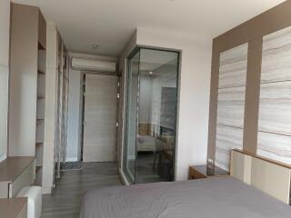 Modern bedroom with built-in storage and glass-enclosed area