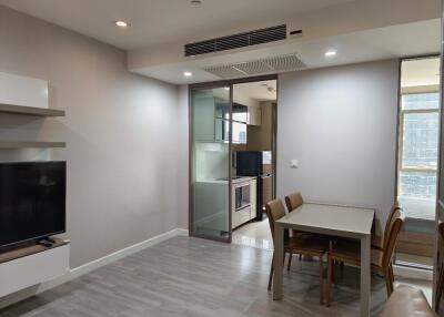 Modern living room with dining area and view into kitchen