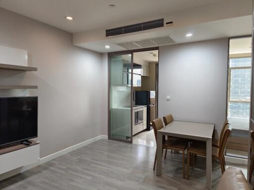 Modern living room with dining area and view into kitchen