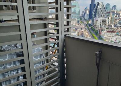 High-rise balcony with a view of the city skyline.