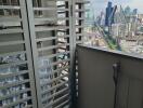 High-rise balcony with a view of the city skyline.