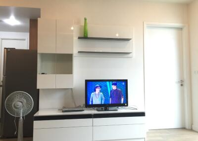 Modern living room with mounted shelves and television