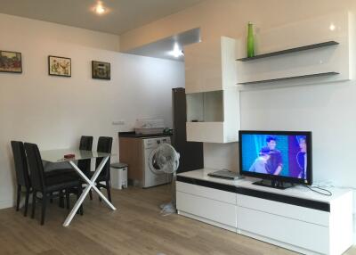 Modern living room with dining area and TV