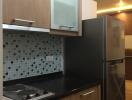 Modern kitchen with wooden cabinets, tile backsplash, and stainless steel fridge