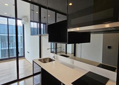 Modern kitchen with black cabinetry and built-in appliances