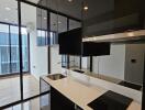 Modern kitchen with black cabinetry and built-in appliances