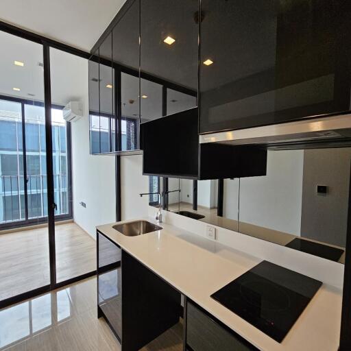 Modern kitchen with black cabinetry and built-in appliances