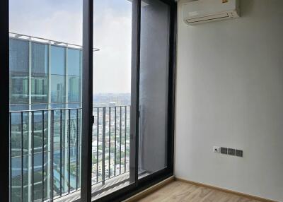 Living area with large window and balcony view