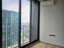 Living area with large window and balcony view