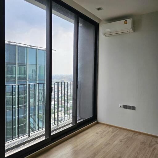 Living area with large window and balcony view