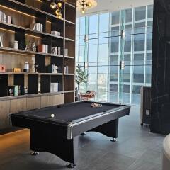 Modern living area with pool table and bookshelf