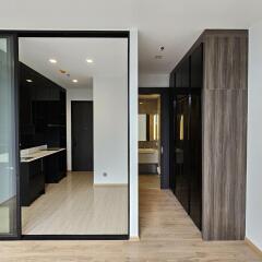 Modern apartment interior with kitchen and bathroom entrance