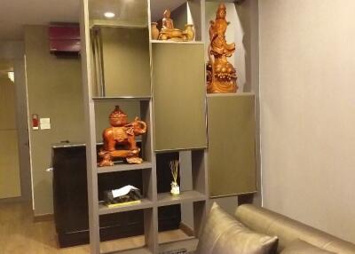 Living room with decorative shelf and wooden flooring