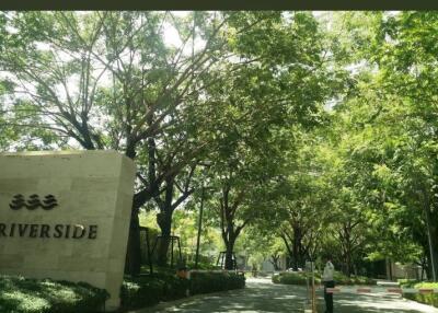 Entrance to Riverside with Trees and Sign