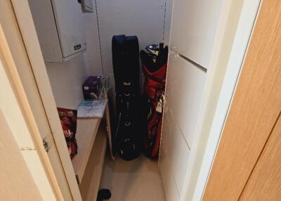 Small storage nook with golf bags and shelves