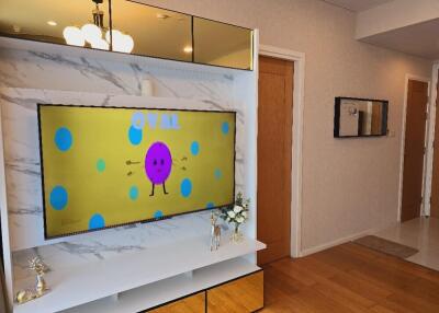 Living room with TV and wooden doors