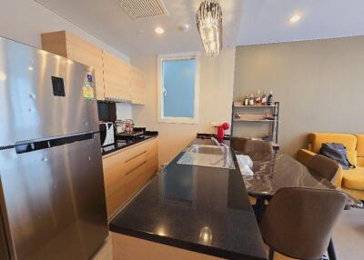 Modern kitchen with island seating and adjacent living area