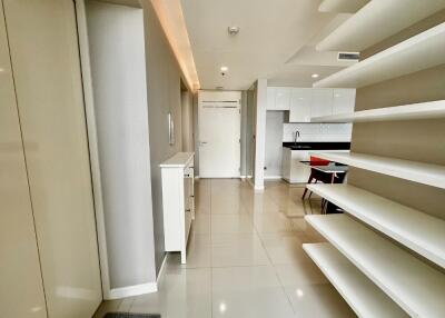 Modern kitchen and hallway with white cabinets and shelves