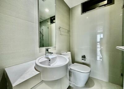 Modern bathroom with sink, toilet, and glass shower