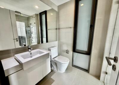 Modern bathroom with large mirror and glass window