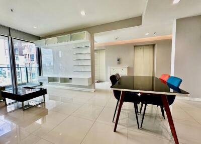 Modern living room with dining area and large windows