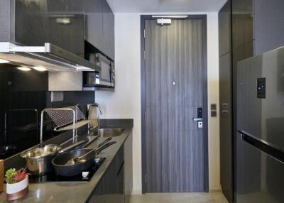 Modern kitchen with dark cabinetry and stainless steel appliances