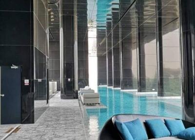 Luxurious indoor swimming pool with seating area