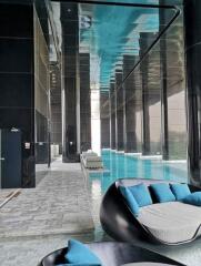 Luxurious indoor swimming pool with seating area