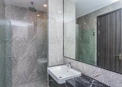 Modern bathroom with marble walls and a large mirror