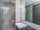 Modern bathroom with marble walls and a large mirror