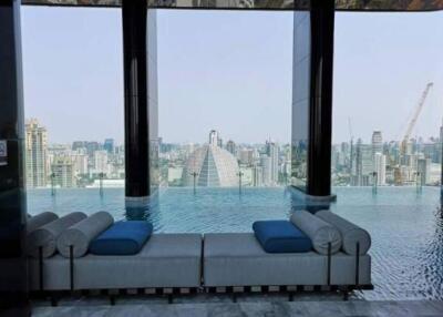 Elegant seating area with an infinity pool and panoramic city view