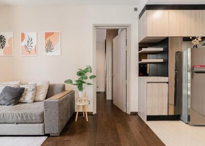 Modern living room with integrated kitchen and hallway view