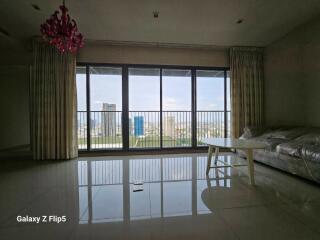 Spacious living room with large windows and city view