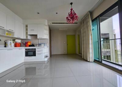 Modern kitchen with white cabinetry and balcony access