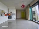 Modern kitchen with white cabinetry and balcony access