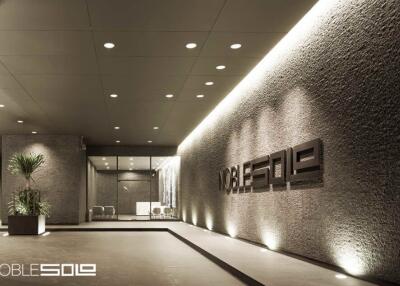 Elegant modern building entrance with signage and lounge area