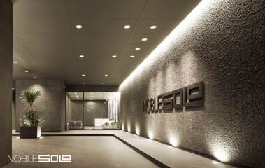 Elegant modern building entrance with signage and lounge area