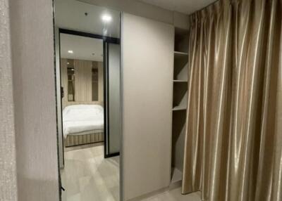 Bedroom with large mirror and shelves