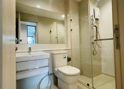 Modern bathroom with glass shower enclosure and large mirror