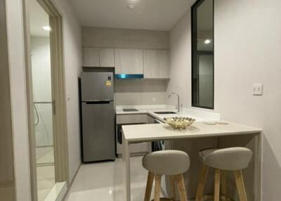 Modern kitchen with a bar counter and two stools