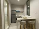 Modern kitchen with a bar counter and two stools