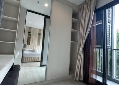 Bright bedroom with large mirrored wardrobe and balcony access