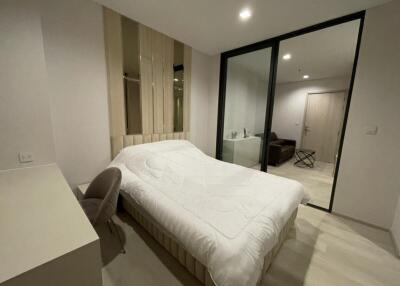 Modern bedroom with bed and attached sitting area