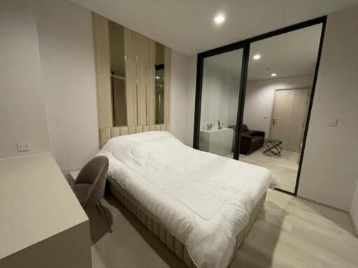 Modern bedroom with bed and attached sitting area