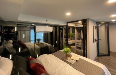 Modern bedroom with cozy bedding and mirrored closet