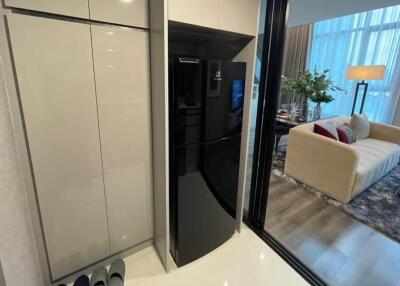 Modern kitchen with a black refrigerator and cabinetry