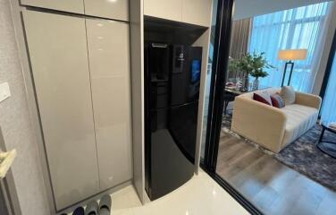 Modern kitchen with a black refrigerator and cabinetry