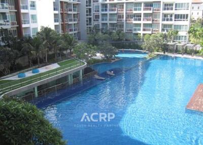 Outdoor swimming pool area with surrounding apartment buildings