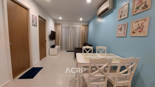 Living room with dining area, air conditioning and wall decorations