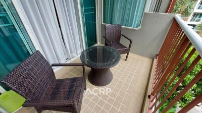 Outdoor balcony with two chairs and a small table